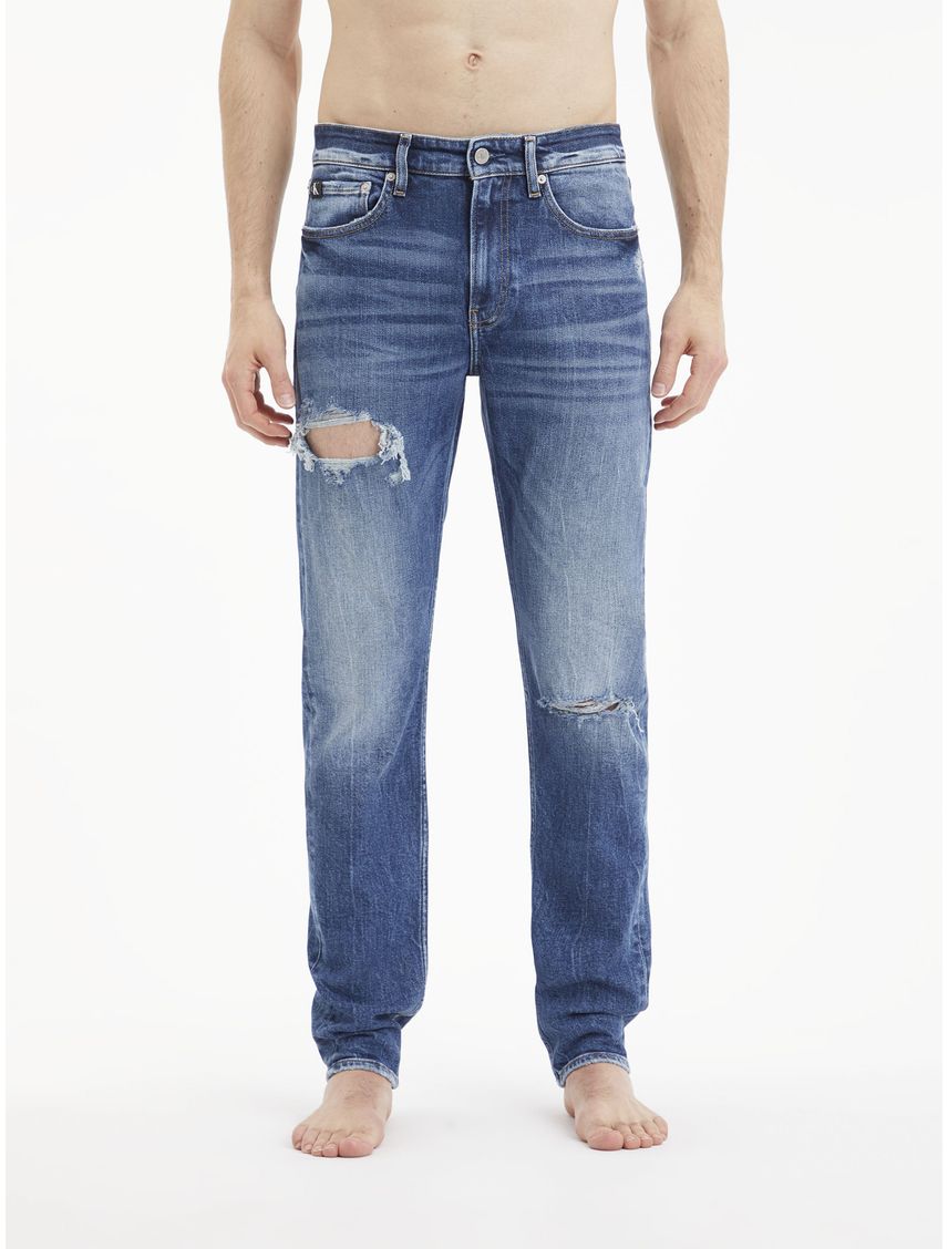 Jeans slim tapered con rotos